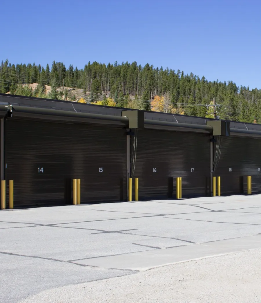 a large black building with yellow and blue doors