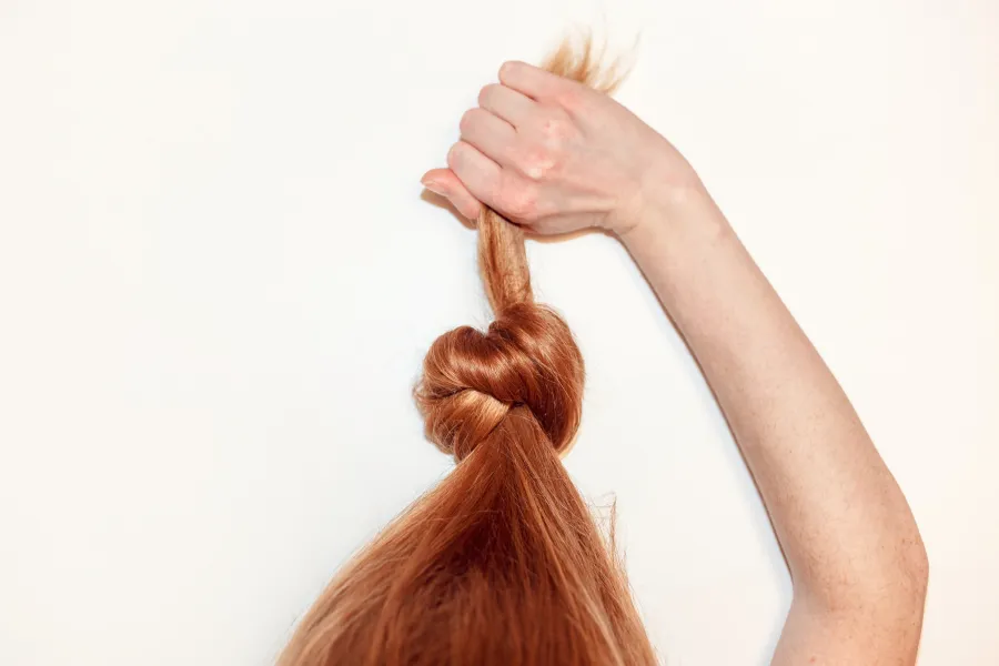 a woman with her hair in the air