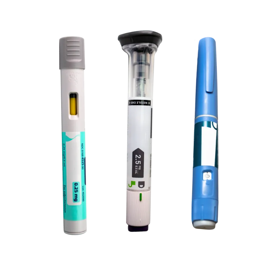 Three different insulin pens with visible dose windows and dosage markings against a white background.