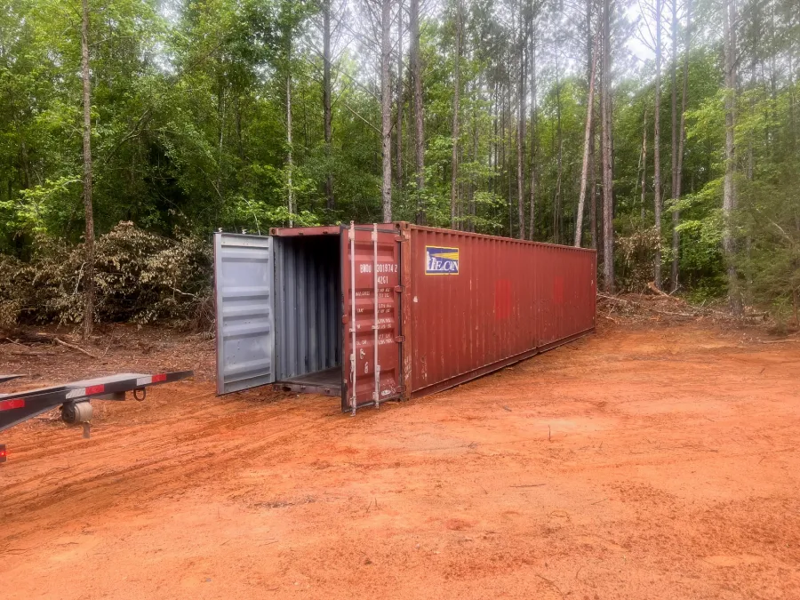 a small metal shed in a forest