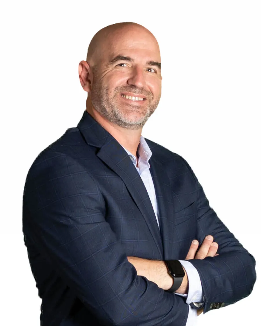 Confident bald man with beard smiling wearing a navy blazer and smartwatch on white background