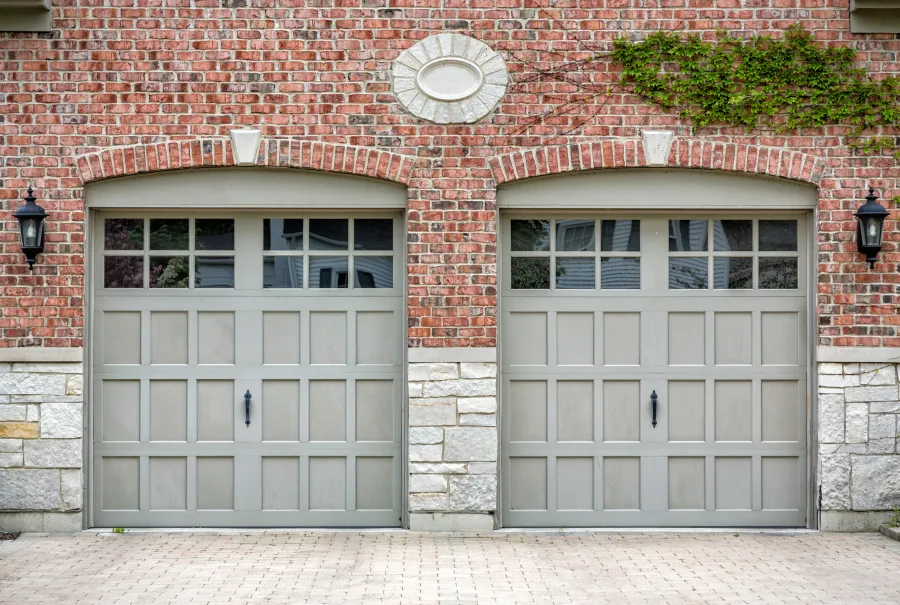 a brick building with two garage doors