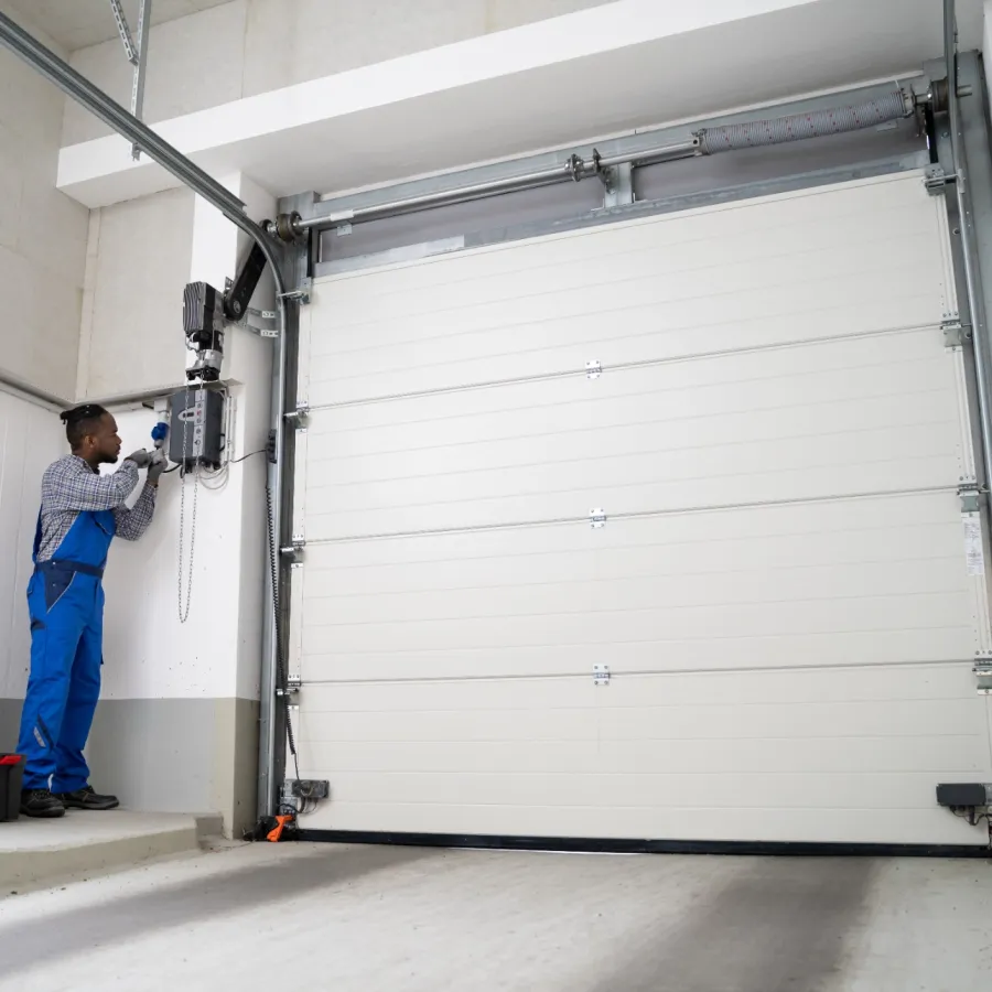 a person standing next to a white garage door