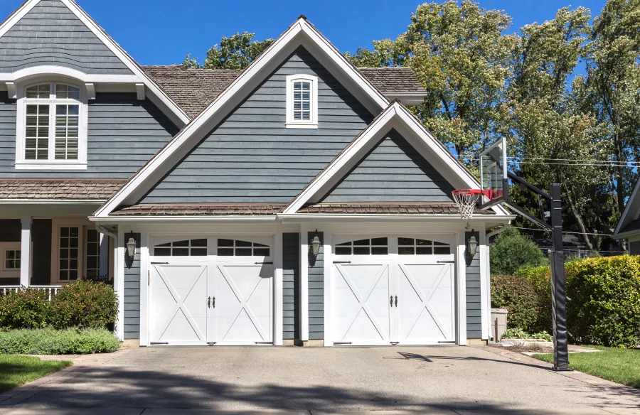 a house with garages and trees with American Gothic House in the background