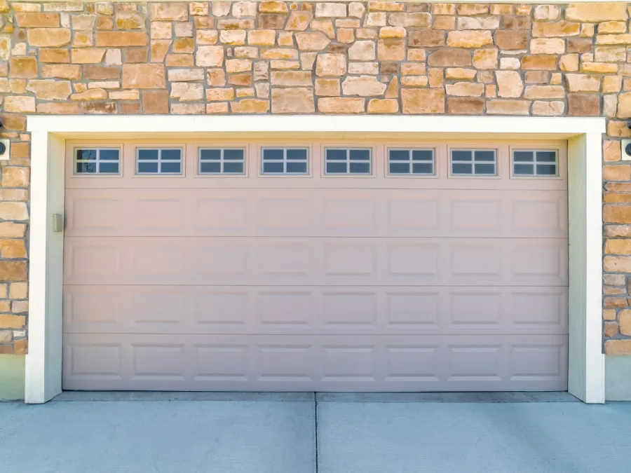 a garage door with a brick wall