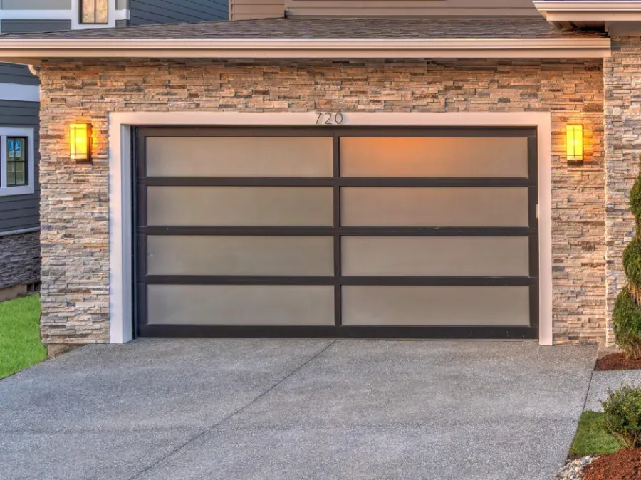 Modern garage door with frosted glass panels and stone facade accents in a contemporary home setting.