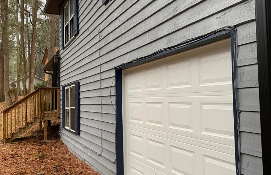 a garage door next to a house