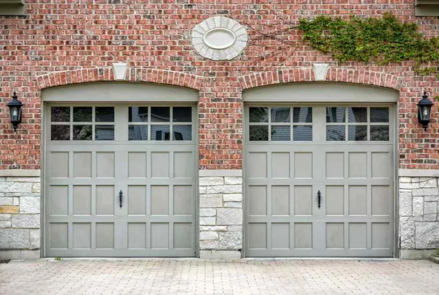 a brick building with two garage doors