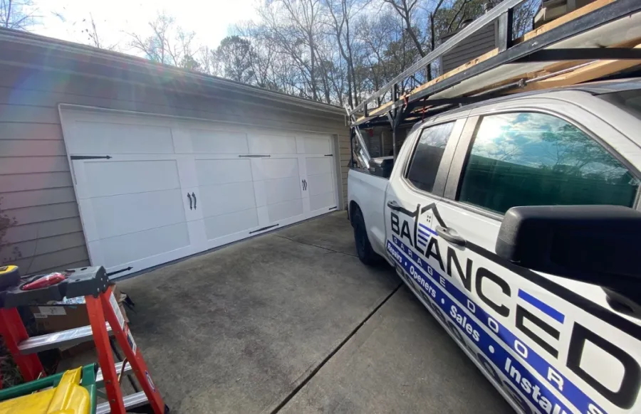 a work truck parked outside a garage