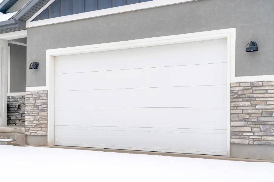 a garage door with a brick wall