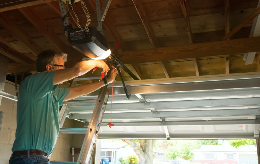 a man repairing  a garage door