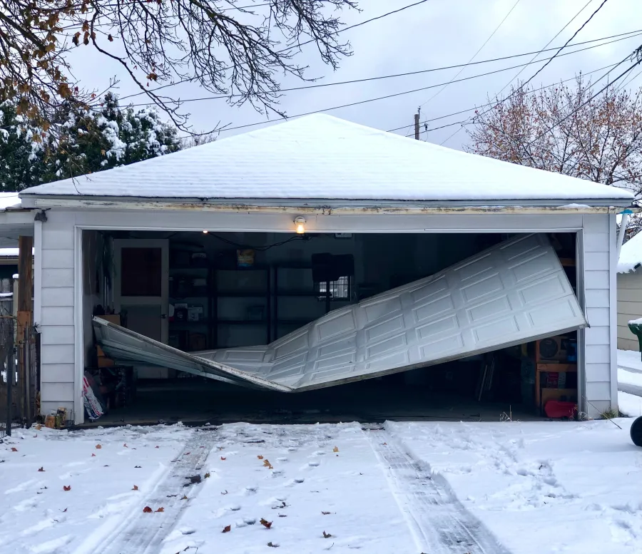 a house with a garage and snow