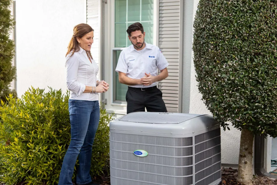 a man and a woman standing next to a radiator