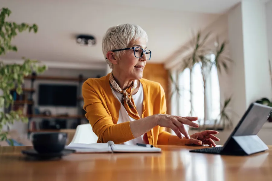 a person sitting at a desk with a laptop