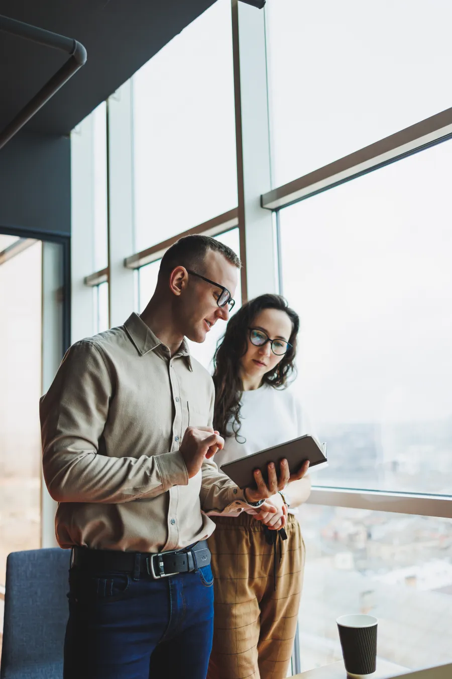 a man and woman looking at a book
