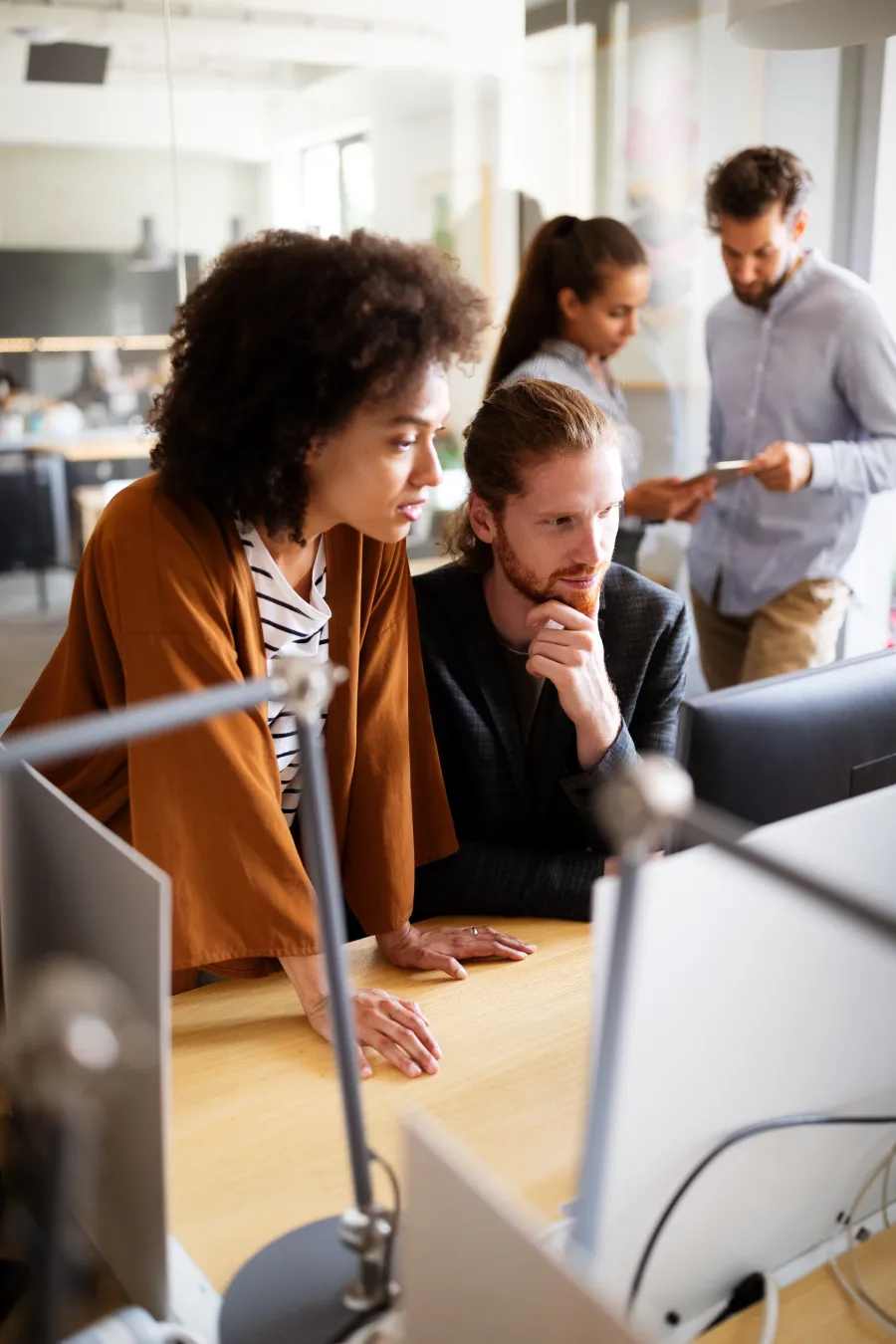 a group of people looking at a computer screen