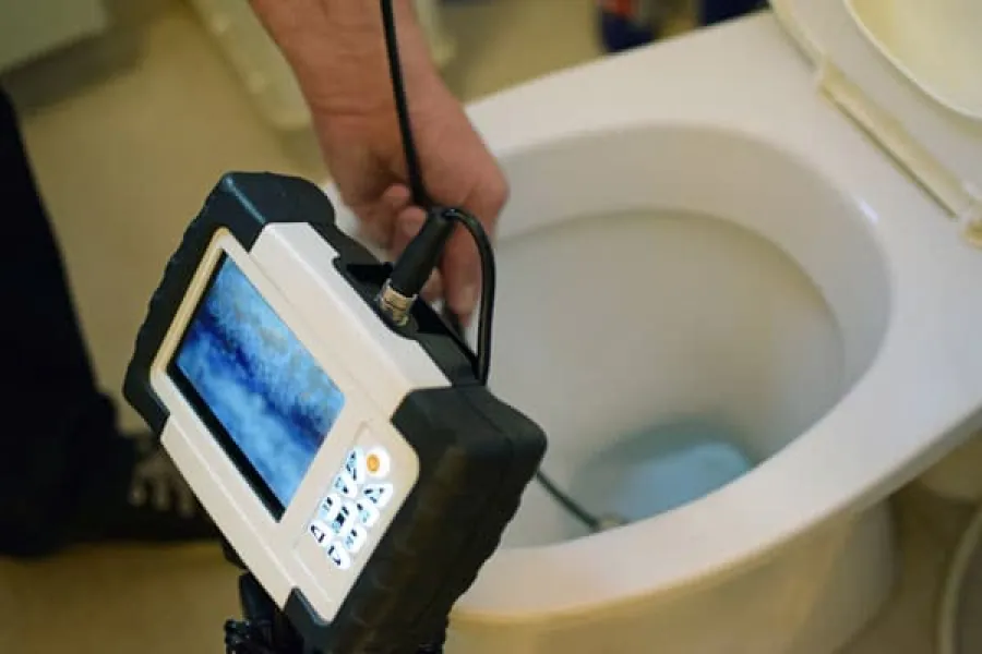 a person using a cell phone in a toilet