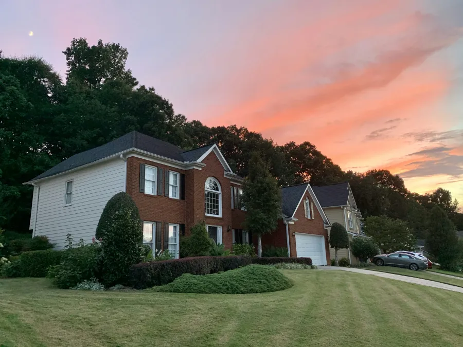 a house with a driveway and a car parked in front of it