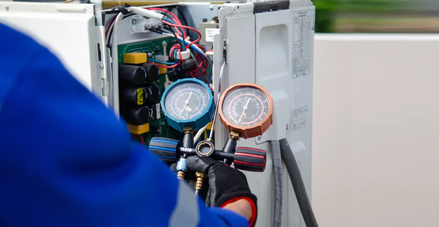 a person wearing a blue helmet and gloves working on a machine