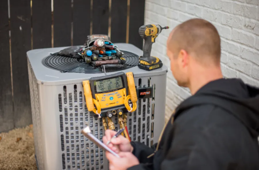 a man using a tool on a machine