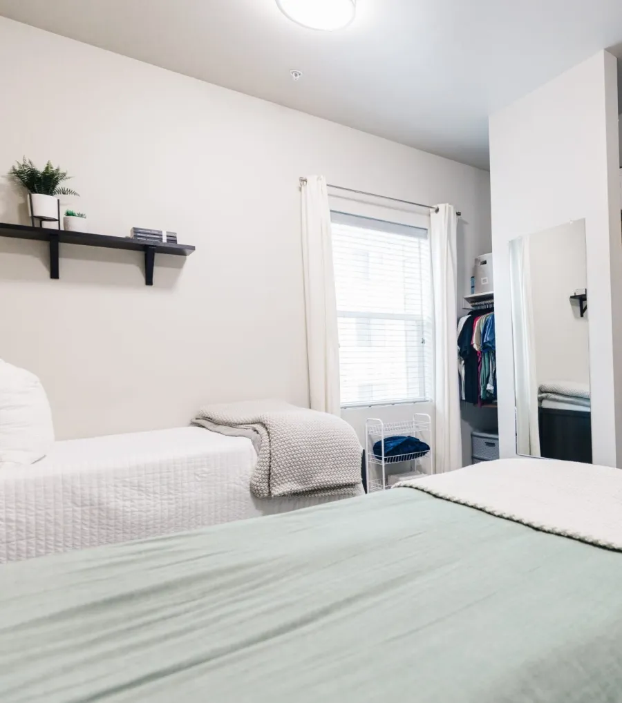 a bedroom with a closet and bed