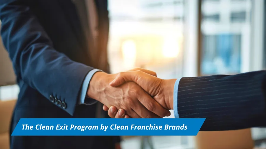 Two business professionals in suits shaking hands symbolizing a clean exit program agreement.