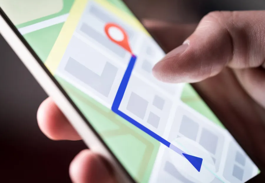 a hand holding a cell phone with map