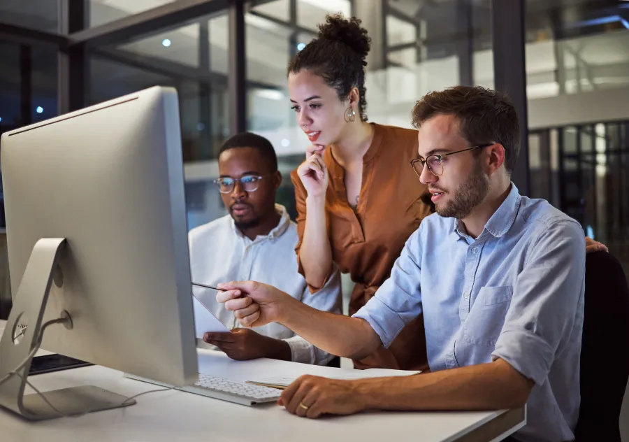 a group of people looking at a computer screen
