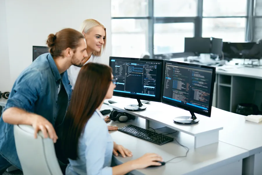 a few people working at a computer