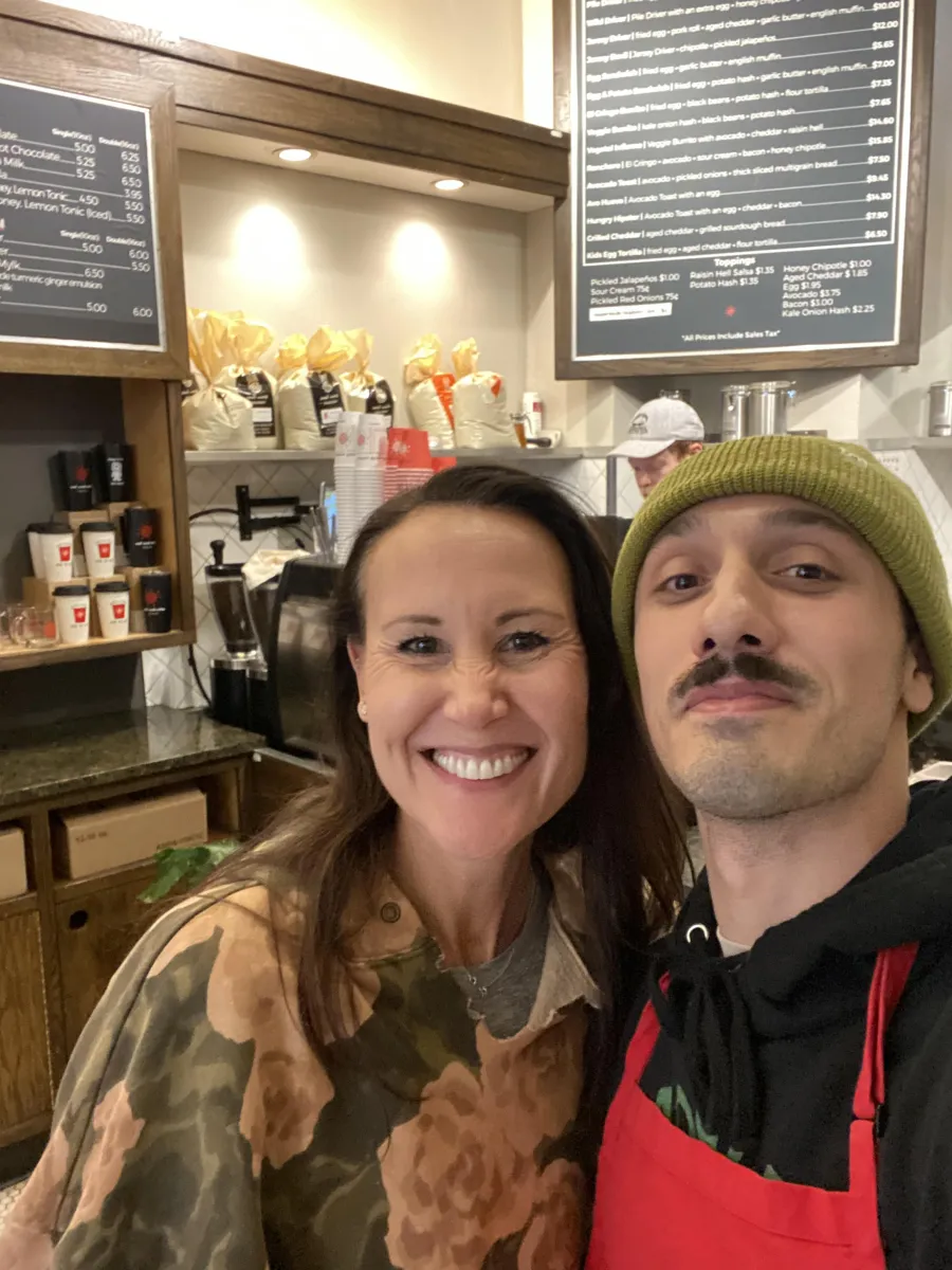 a man and woman taking a selfie in a restaurant