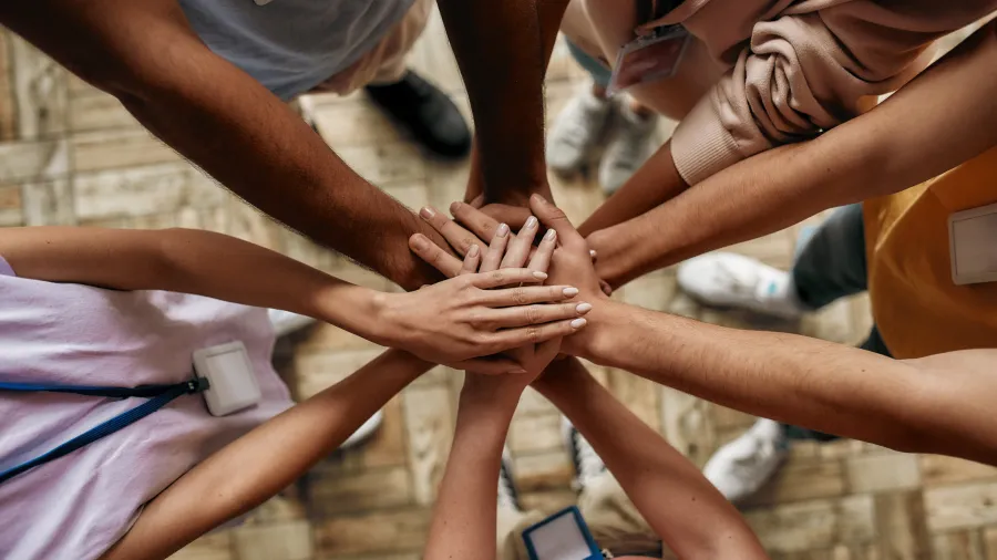 a group of people holding hands