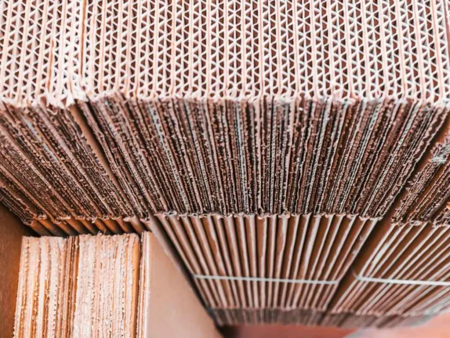 Close-up view of stacked corrugated cardboard sheets showing texture and layers