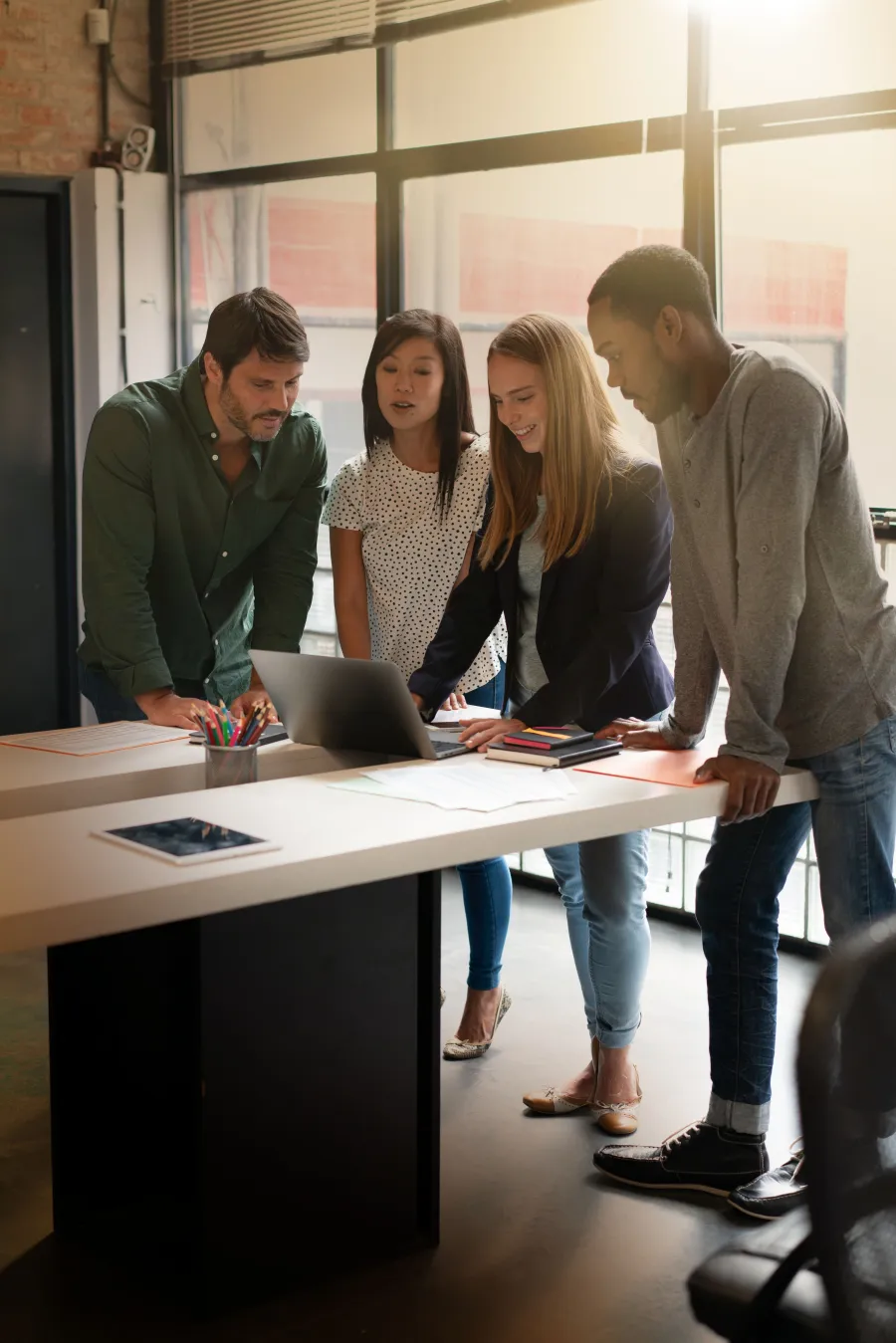a group of people standing around a table