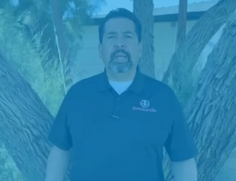 a man standing in front of a large fish tank