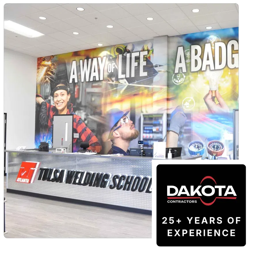 Lobby of Tulsa Welding School with large wall mural showing workers and slogan A Way of Life, A Badge, and a service desk.