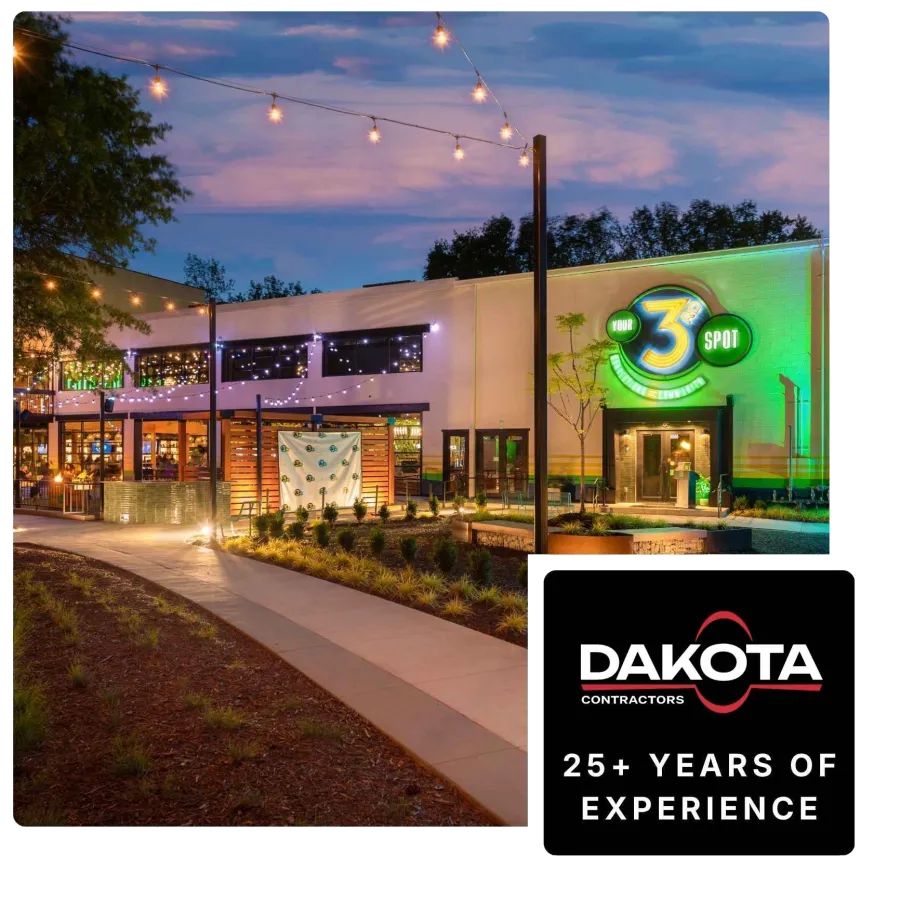 Evening exterior view of a modern restaurant with string lights and Your 3rd Spot neon sign glowing