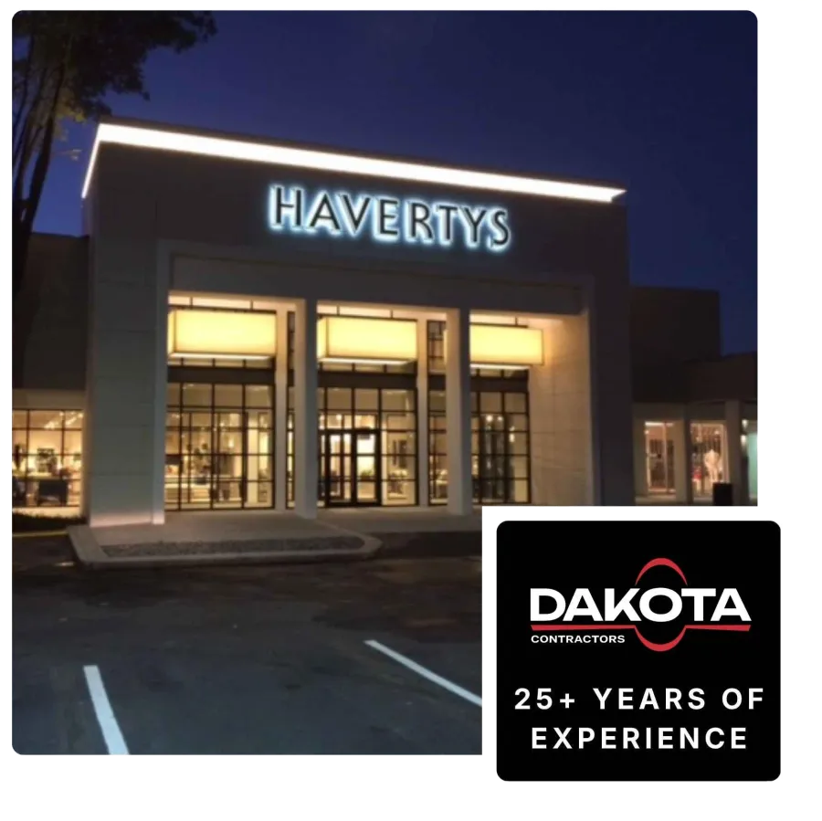 Night view of Havertys furniture store exterior with illuminated entrance and signage.