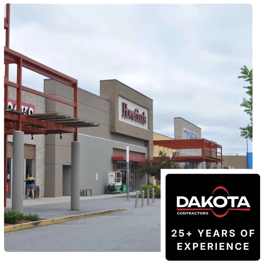 Shopping center exterior featuring HomeGoods storefront under cloudy sky with red architectural accents