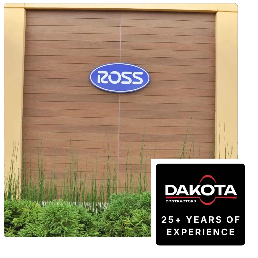 Blue Ross logo on wooden wall with green plants in front and Dakota Contractors 25+ years advertisement.