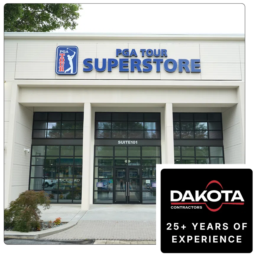 Exterior view of PGA Tour Superstore entrance with large blue signage above glass doors under Suite 101.