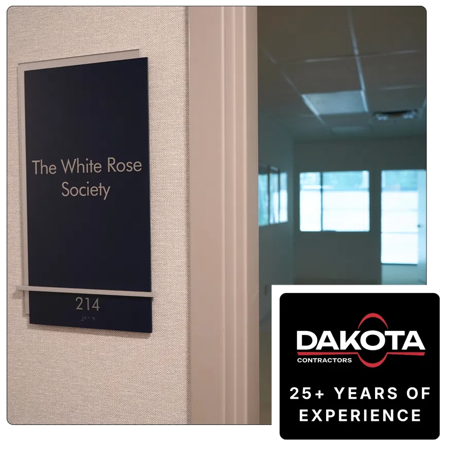Office door sign for The White Rose Society room 214 with a Dakota Contractors logo overlay