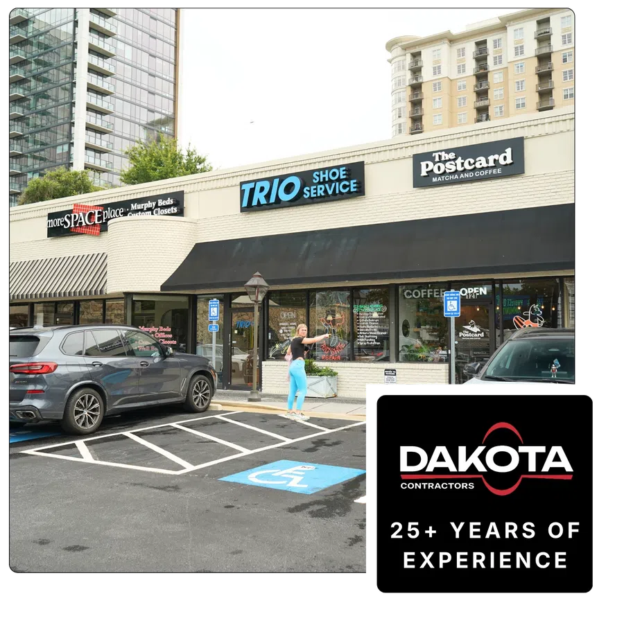 Street view of storefronts including Trio Shoe Service and The Postcard coffee shop with parked cars and a person outside.