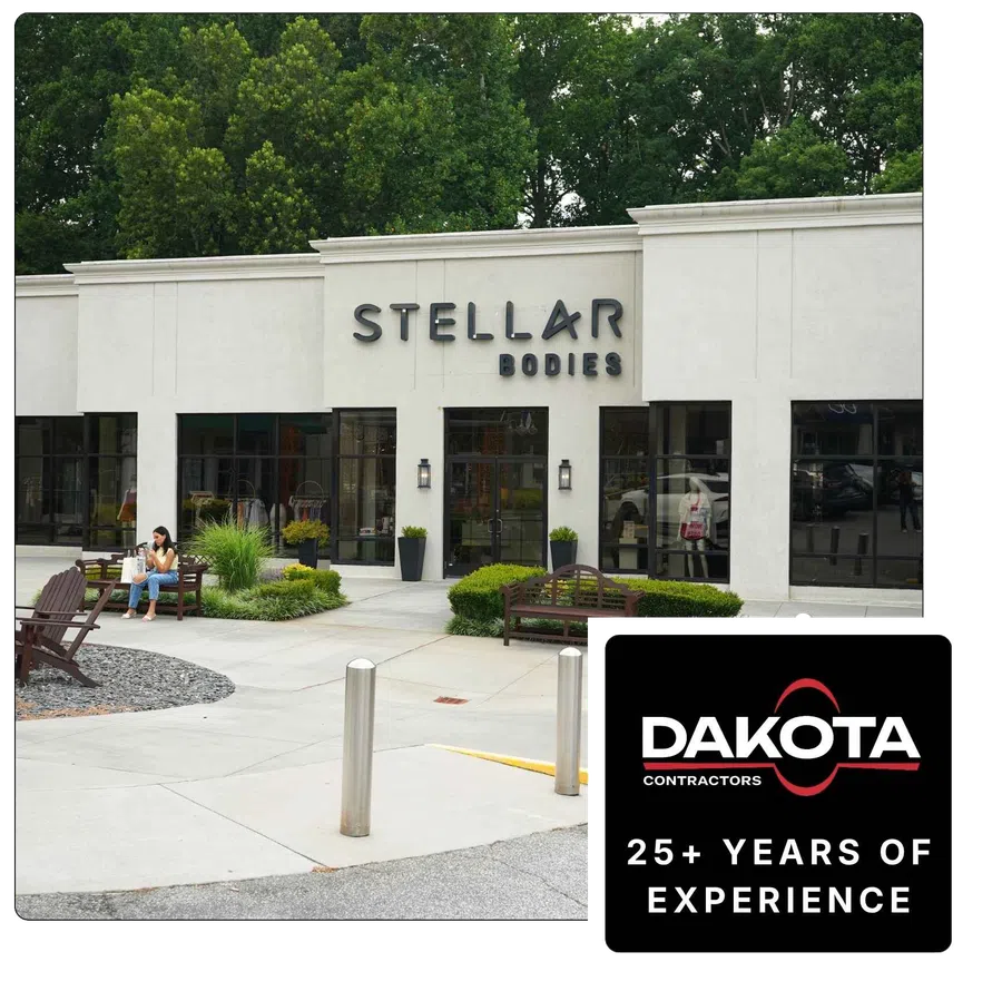 Entrance of Stellar Bodies fitness studio with glass doors, signage, and workout equipment visible inside.