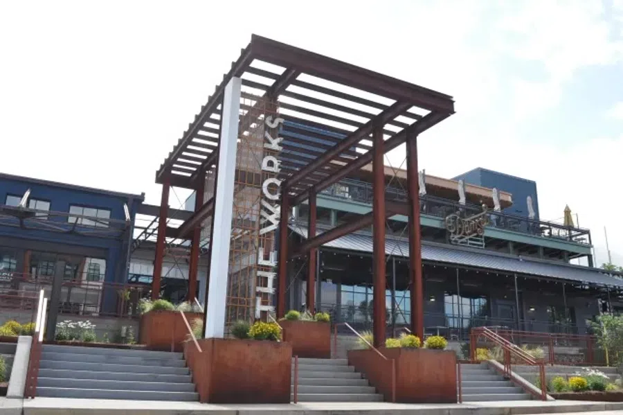 Modern entrance structure with steel beams and stairs at The Works commercial building