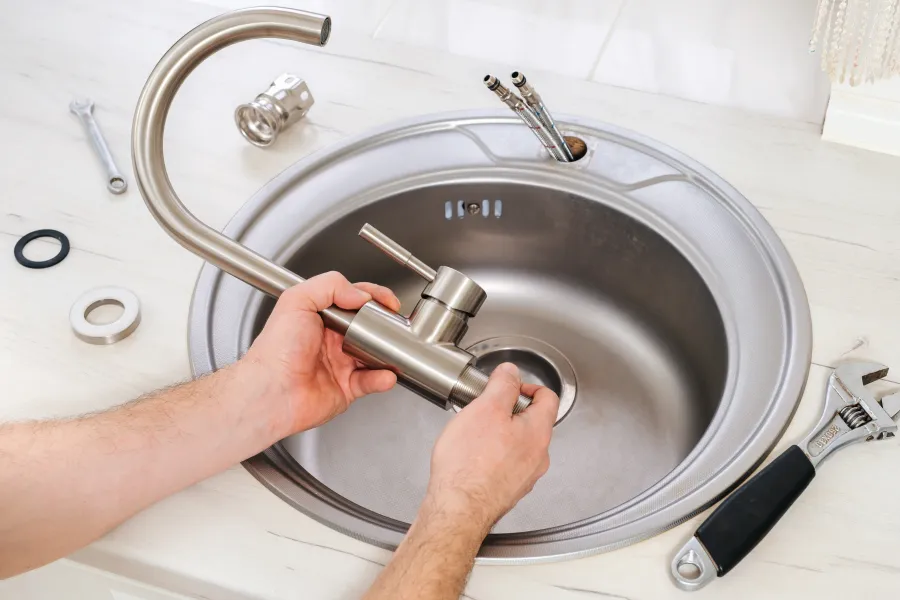 a person washing a sink