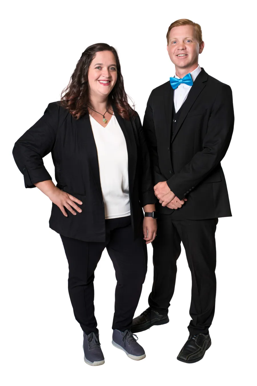Smiling man and woman standing side by side wearing formal black suits on white background