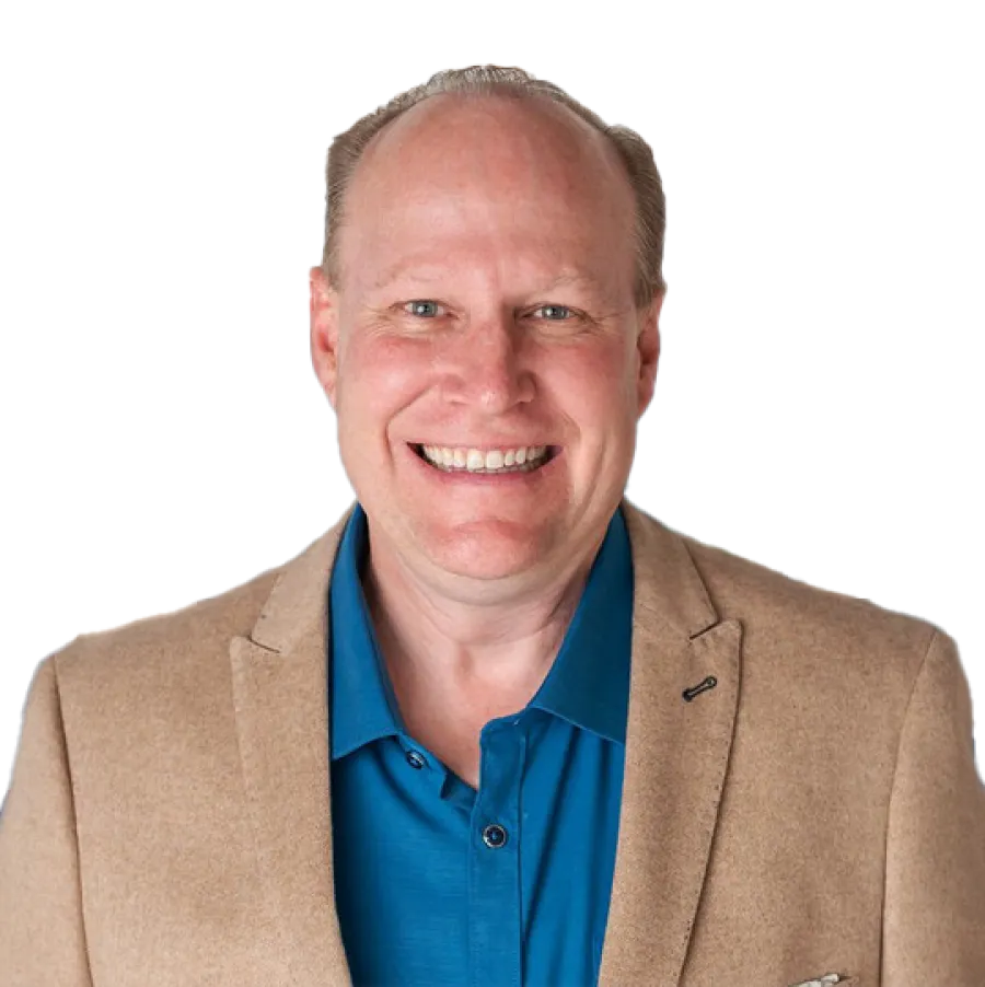 Smiling middle-aged man in a blue shirt and tan blazer against a transparent background