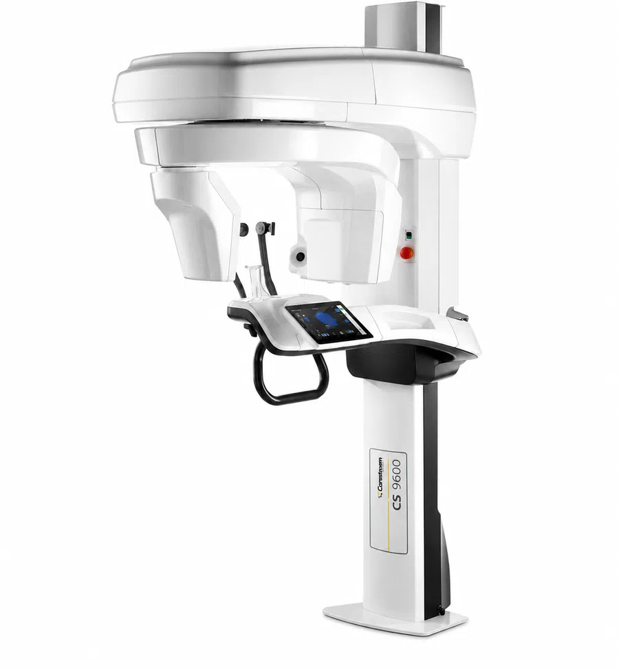 White CS 9600 dental 3D imaging machine with touchscreen and adjustable head support on white background