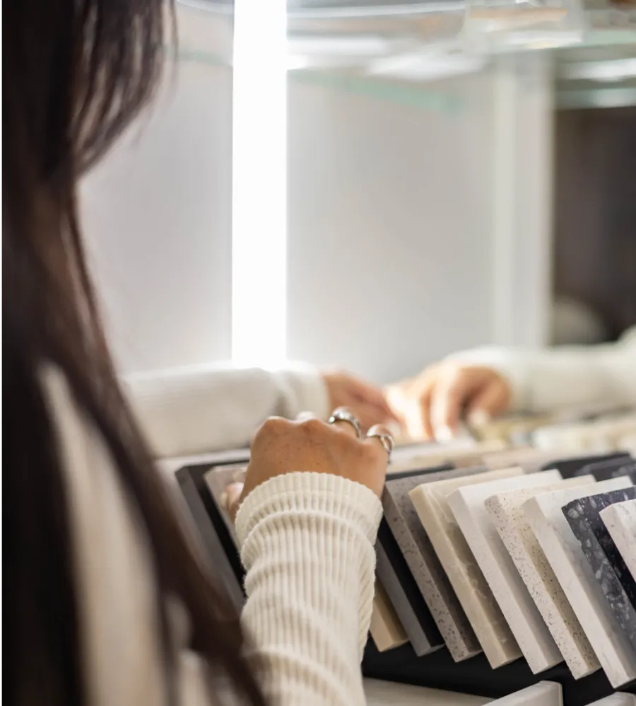 a person looking through countertop samples