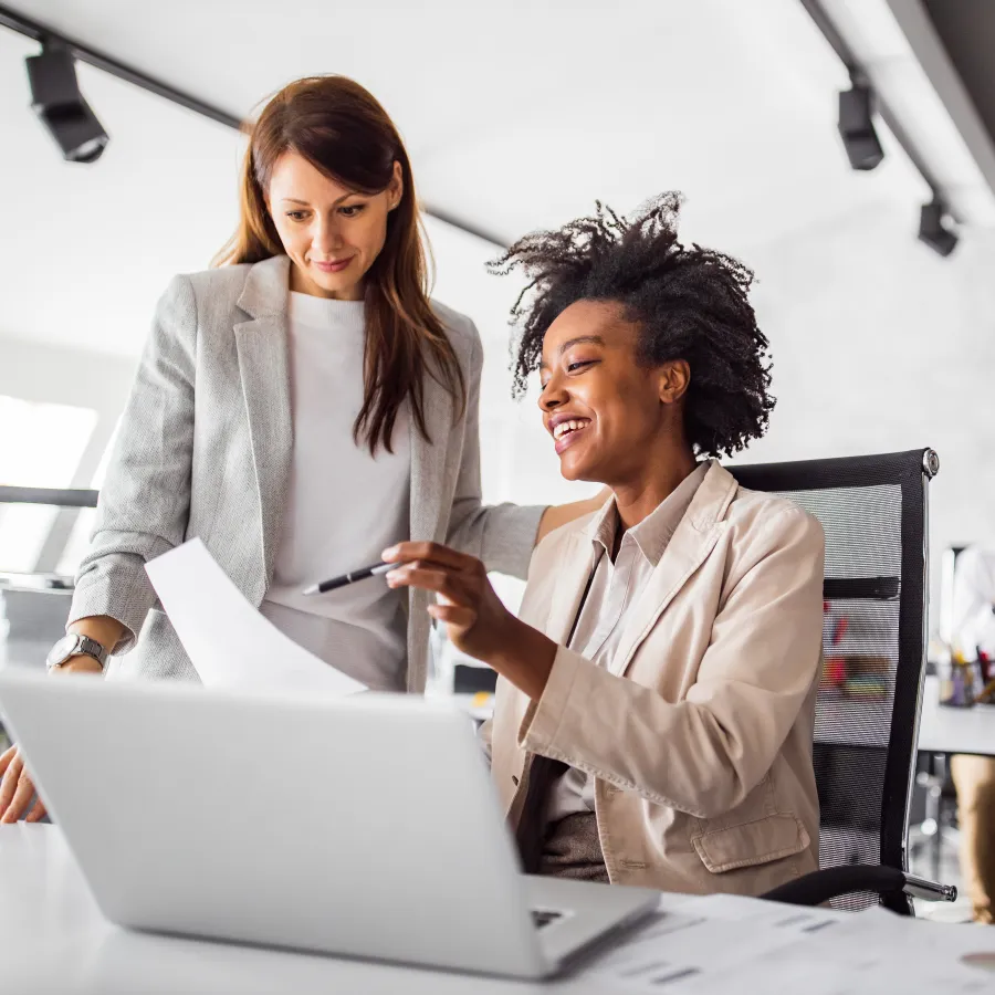 a woman showing something on the laptop to a man